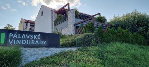 a house on a hill with a sign in front of it at Apartmán Pavlov Pálavské vinohrady in Pavlov