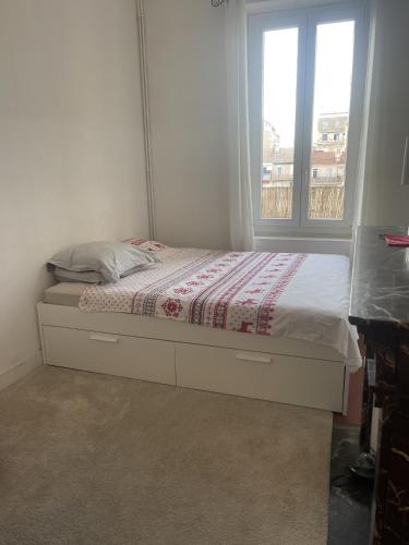 un lit dans une chambre avec une fenêtre dans l'établissement Appartement Marseille 13008 - 5min à pied Stade Vélodrome, à Marseille
