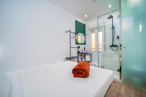 a bedroom with a bed and a glass shower at AngelitoMAD in Madrid