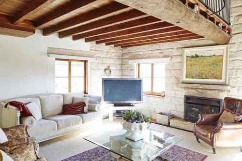 a living room with a couch and a fireplace at Talits Estate Vineyard in Broke