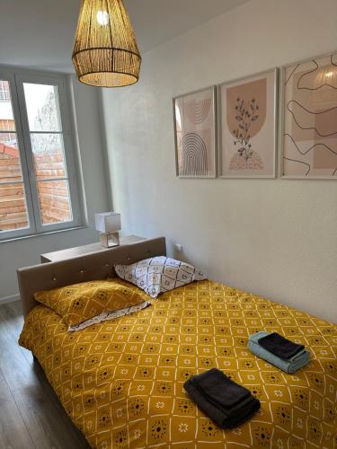 a bedroom with a bed with two towels on it at Appartement avec terrasse au Puy in Le Puy en Velay