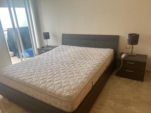 Ένα ή περισσότερα κρεβάτια σε δωμάτιο στο Appartement CasaBay Sidi Rahal