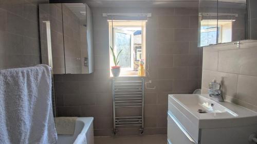 a bathroom with a sink and a toilet and a window at Modern holiday let in Skipton, North Yorkshire in Skipton