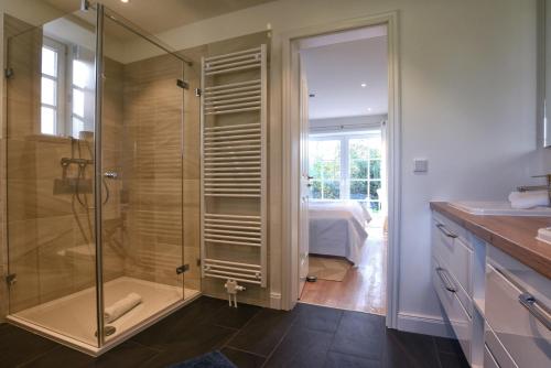 a bathroom with a shower with a glass door at Huus Leeftalich in Alkersum
