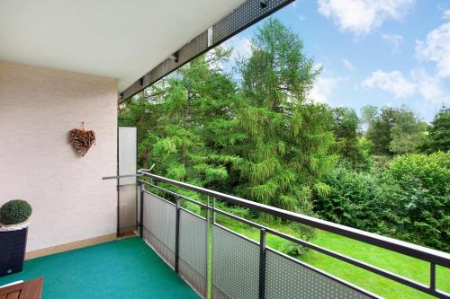 an outdoor balcony with a view of trees at Kleine Auszeit in Brilon