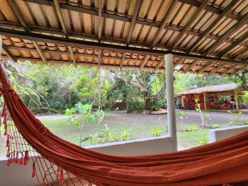 a hammock in a room with a view of a yard at Pousada Vila Gaia in Santo André