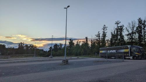 a truck is parked on the side of a road at BUSINESS-MOTEL, free XL-Parking, eCharging, Self Checkin, Massage, Sauna in Heimsheim
