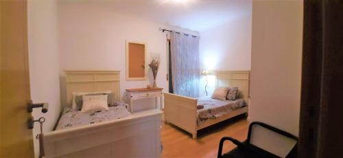 a bedroom with two beds and a mirror at Apartment in the center of Tavira with swimming pool and garage in Tavira