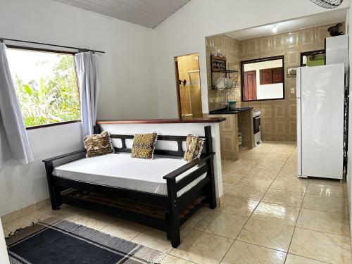um quarto com uma cama numa cozinha com uma janela em Casa Perto do Centro em Paraty
