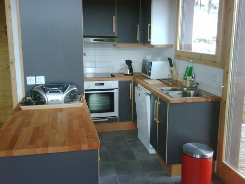 a small kitchen with a sink and a stove at LA PLAGNE MONTALBERT Chalet - fitness - wifi 