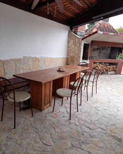 a wooden table and chairs on a stone patio at Apartmani Kober in Šibenik