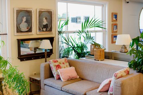 a living room with a couch and some plants at Hotel Los Ángeles Denia in Denia