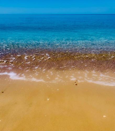 a sandy beach with the ocean in the background at Villa Marna Bianca in Borgo Bonsignore