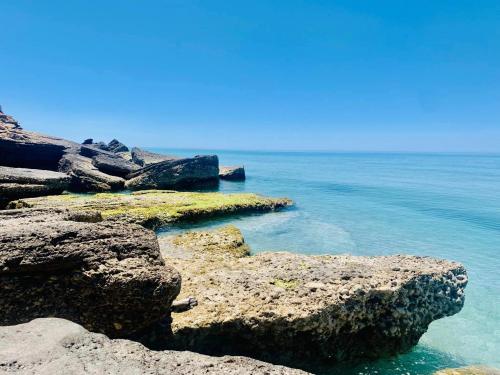 a view of the ocean with rocks in the water at Villa Marna Bianca in Borgo Bonsignore