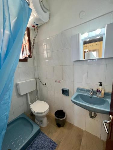 a bathroom with a toilet and a sink at Mouse Island View Studios in Perama