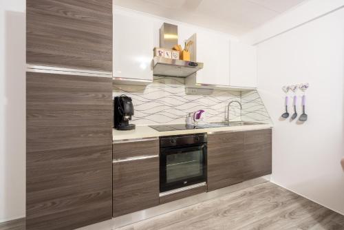 a kitchen with a sink and a stove at Relax Derossi 2 in Crikvenica