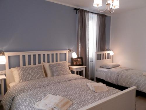 a blue bedroom with two beds and a window at Apartment Kiki Candy in Malinska