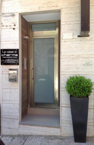 a glass door on a building with a potted plant at La Casa di Charme in Ragusa