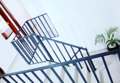 a blue metal staircase with a potted plant on it at Sofitel 3 bedrooms own compound milimani in Kisumu