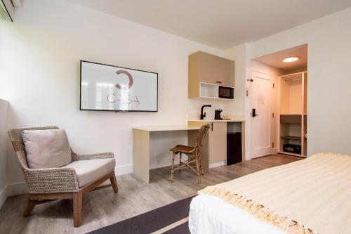 een slaapkamer met een bed, een bureau en een stoel bij Casa Sofi in Miami Beach