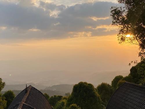 a view of the sunset from the roof of a house at La Cascata Bali Munduk in Munduk