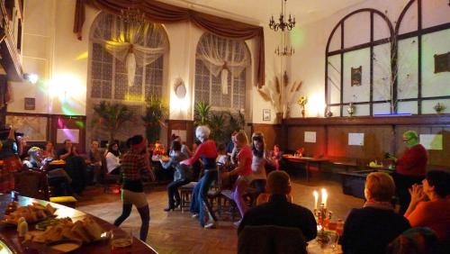 a group of people sitting in a room with a party at Wrzos & Belvedere in Kudowa-Zdrój