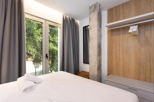 a bedroom with a bed and a large window at Guimerá Family Suites A in Santa Cruz de Tenerife