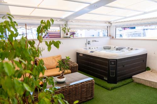 a bathroom with a large tub in a room with green grass at PALAZZO NICOLAUS del BORGO ANTICO in Bari