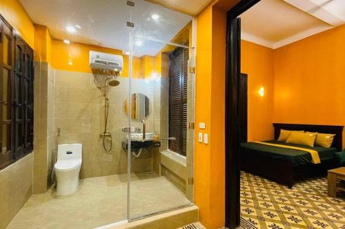 a bathroom with a shower and a toilet and a bed at Old Quarter Autumn Hanoi in Hanoi