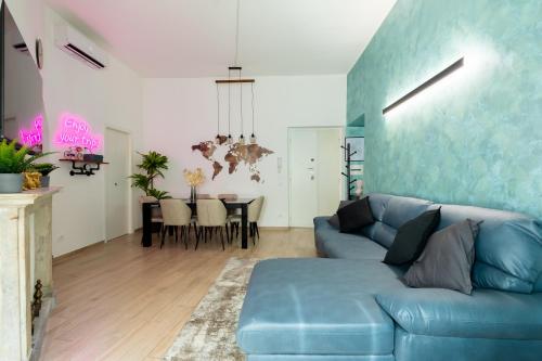 a living room with a blue couch and a table at Maison Piazza di Spagna in Rome