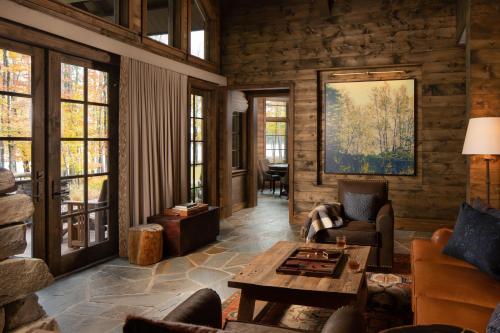 a living room filled with furniture and a table at The Chatwal Lodge (All-Inclusive) - in The Unbound Collection by Hyatt in White Lake
