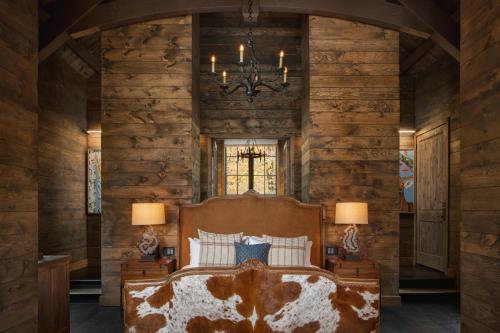 a bedroom with a large bed in a room with wooden walls at The Chatwal Lodge (All-Inclusive) - in The Unbound Collection by Hyatt in White Lake