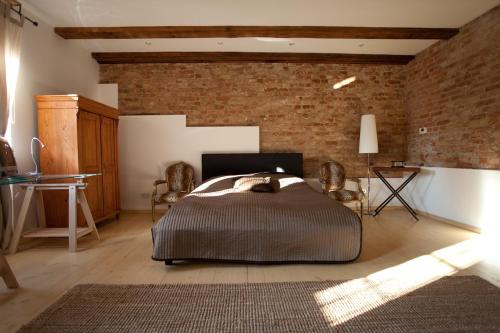 a bedroom with a bed and a brick wall at Smart Appart Blücher Berlin in Berlin