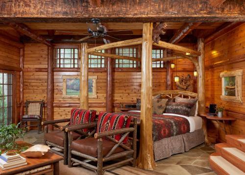 a bedroom in a log cabin with a bed and chairs at The Chatwal Lodge (All-Inclusive) - in The Unbound Collection by Hyatt in White Lake