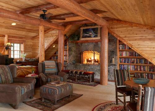 a living room with a fireplace in a log cabin at The Chatwal Lodge (All-Inclusive) - in The Unbound Collection by Hyatt in White Lake