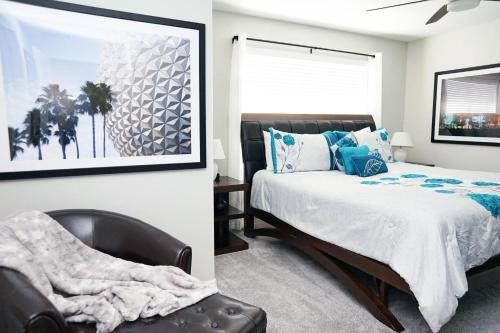 a bedroom with a bed and a chair at Candy Palm 8885 Water View Townhouse, Sleeps 12 in Kissimmee