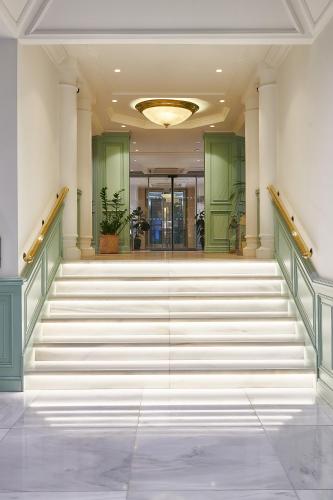 a hallway with stairs in a building at Melia White House Hotel in London