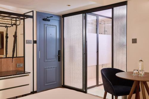 a room with a blue door and a table at Melia White House Hotel in London