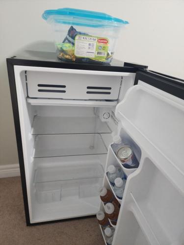 an open refrigerator filled with food and drinks at Prestige Guest Room London Ontario in London
