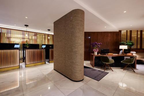 a lobby with a large brick pillar in a building at Melia White House Hotel in London