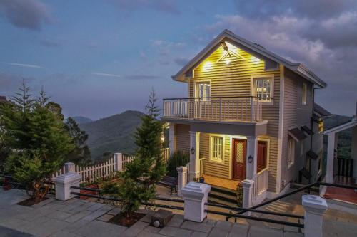 a house with a light on the side of it at Eagles Wings Abode in Coonoor
