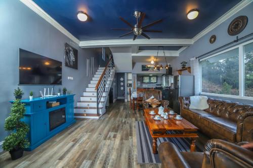 a living room with a couch and a table at Eagles Wings Abode in Coonoor