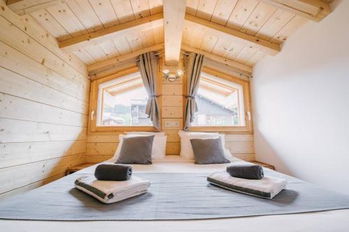 a bed in a tiny house with windows at The Alpine Lodge in Les Gets