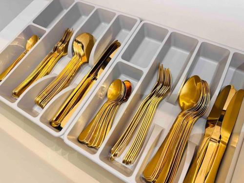 a tray of gold teaspoons and forks and spoons at SKVilla private pool+ktv+bbq+starview up to 35pax in Ayer Keroh