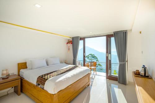 a bedroom with a bed and a balcony at Tegal Sari Cabin Kintamani in Kintamani