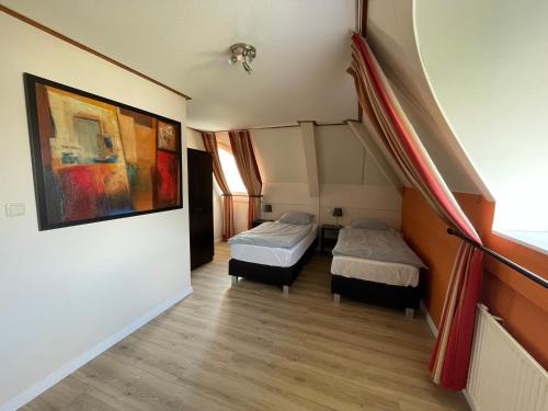 a room with two beds and a staircase at Holiday Beach House Hellevoetsluis in Hellevoetsluis