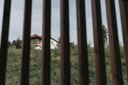 an old house in a field through a barred window at Das Dietrich - Landhaus 64 in Leibnitz