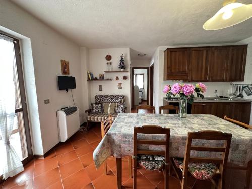 kuchnia i jadalnia ze stołem i krzesłami w obiekcie Appartamento Fiore Rocca w mieście Rocca di Mezzo