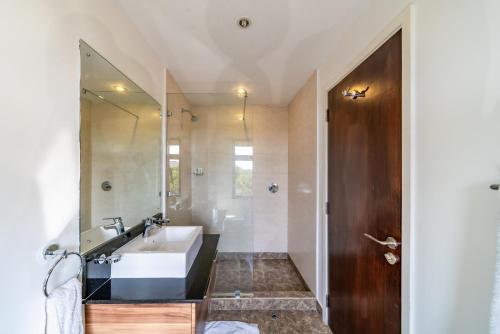 a bathroom with a sink and a mirror at Ol Pejeta Mansion in Nanyuki