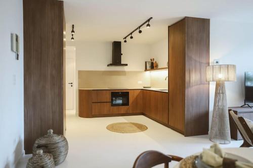 a living room with a kitchen with a table at Appartement in Antwerpen in Antwerp